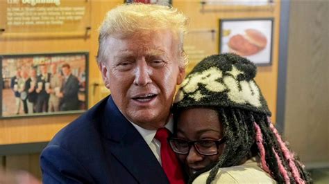 black girl hugging trump